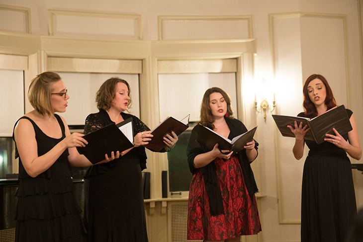 Vocal quartet Ignea Strata performing in an intimate recital space.